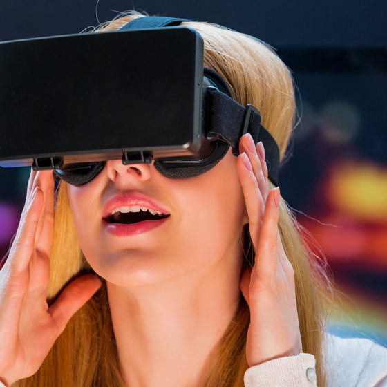 blonde woman trying Virtual Reality headset
