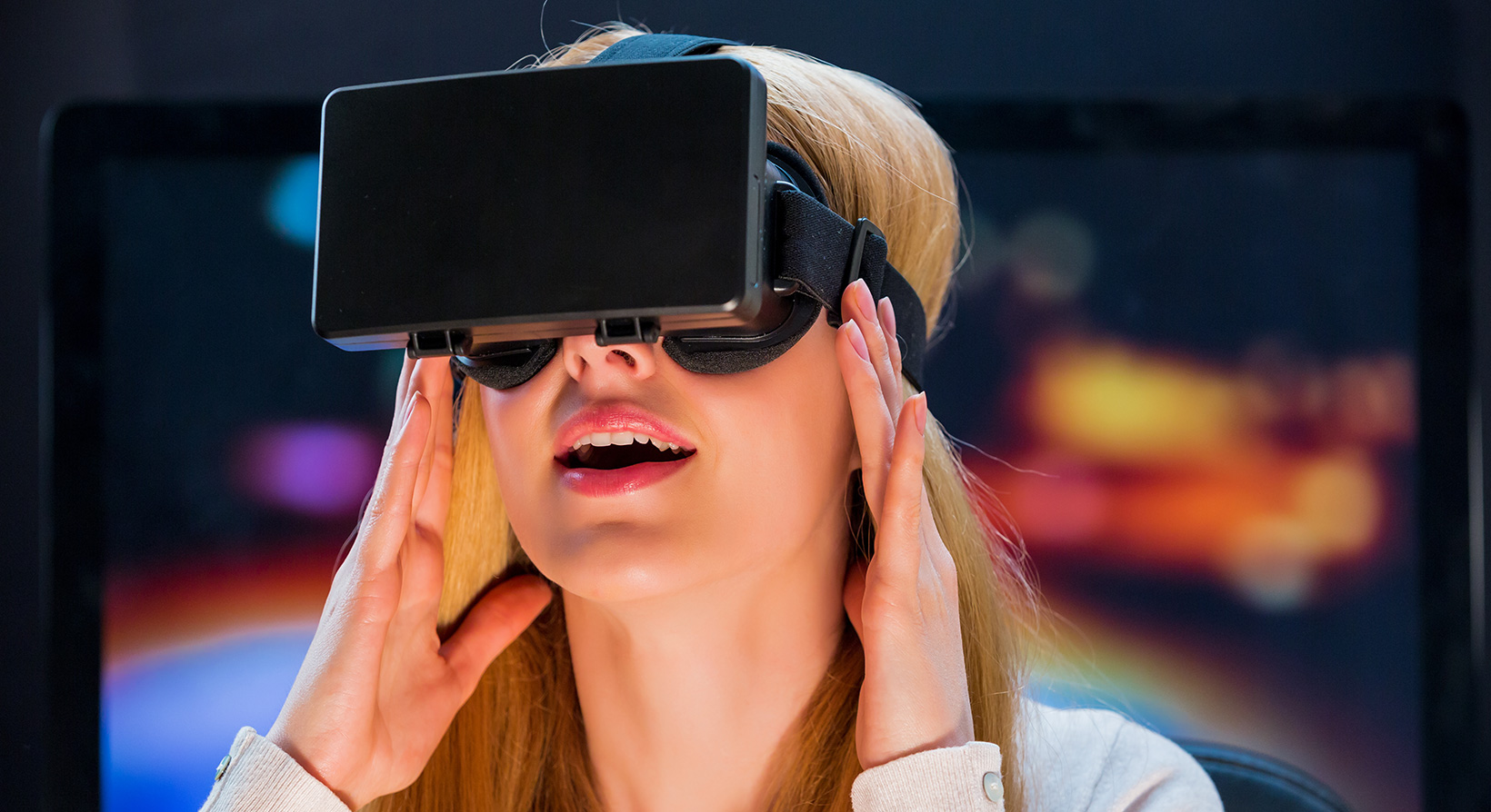 blonde woman trying Virtual Reality headset