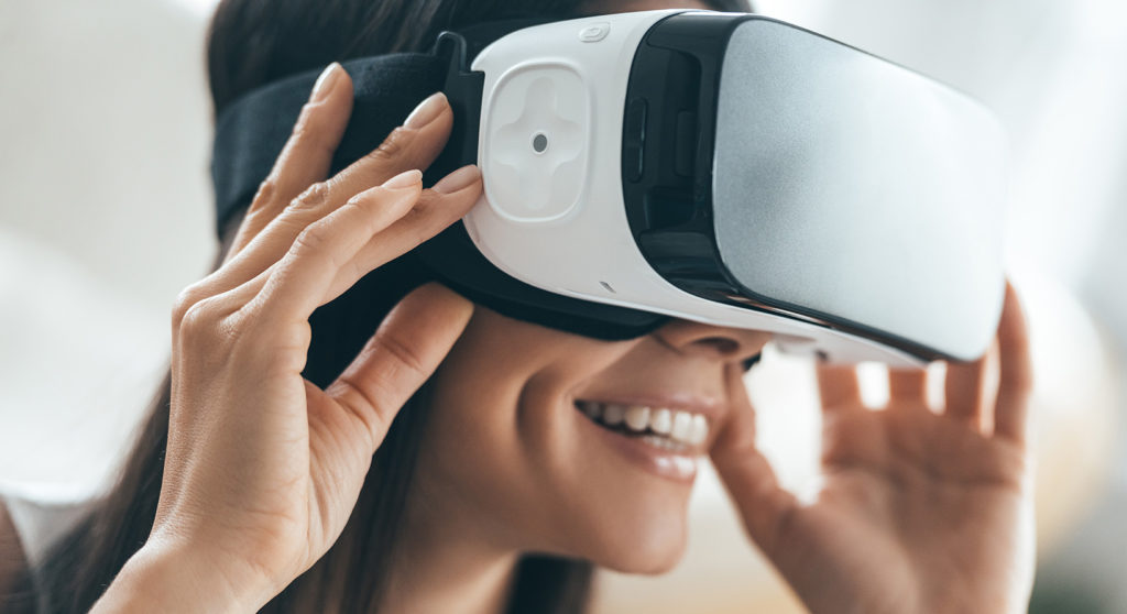 Woman wearing virtual reality headset and smiling