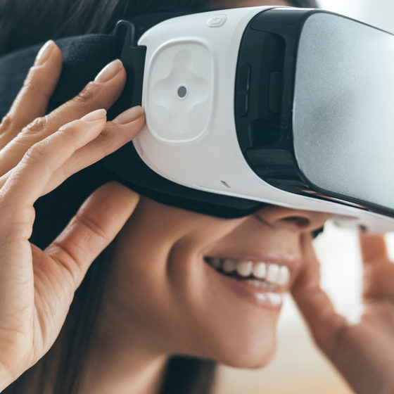 Woman wearing virtual reality headset and smiling