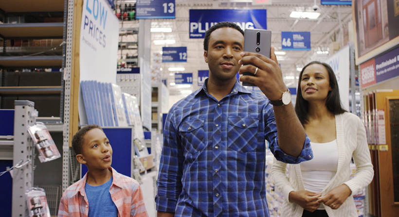 young couple with a kid in retail store checking AR app