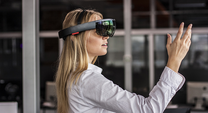 Young, blonde female wearing hololens headset