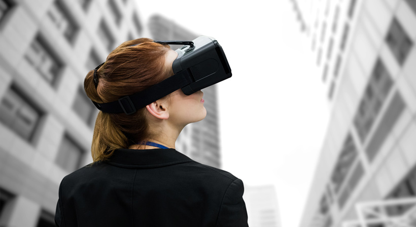 young woman wearing virtual reality headset among highrise buildings