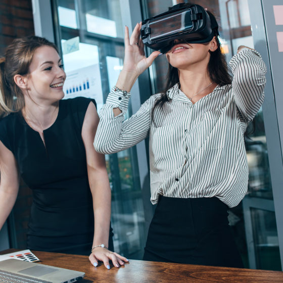 two female office workers are going through training with Virtual Reality