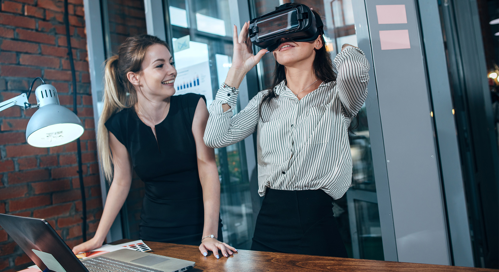 two female office workers are going through training with Virtual Reality