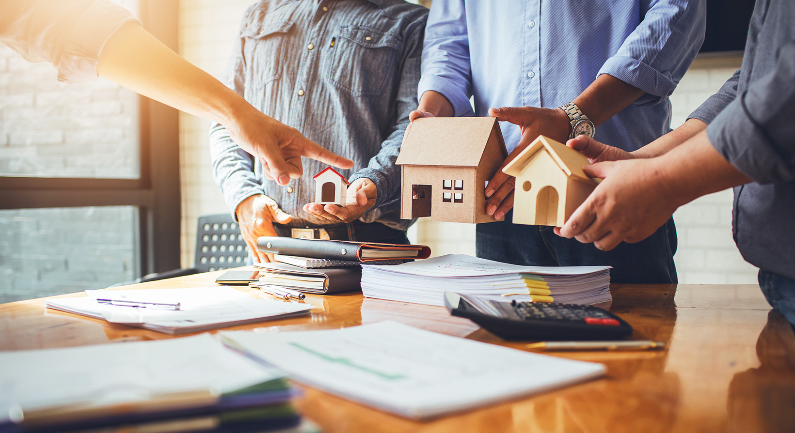 real estate developers in a meeting discussing over model houses