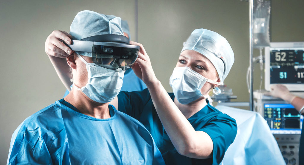 a nurse helping surgeon to wear hololens in operating room
