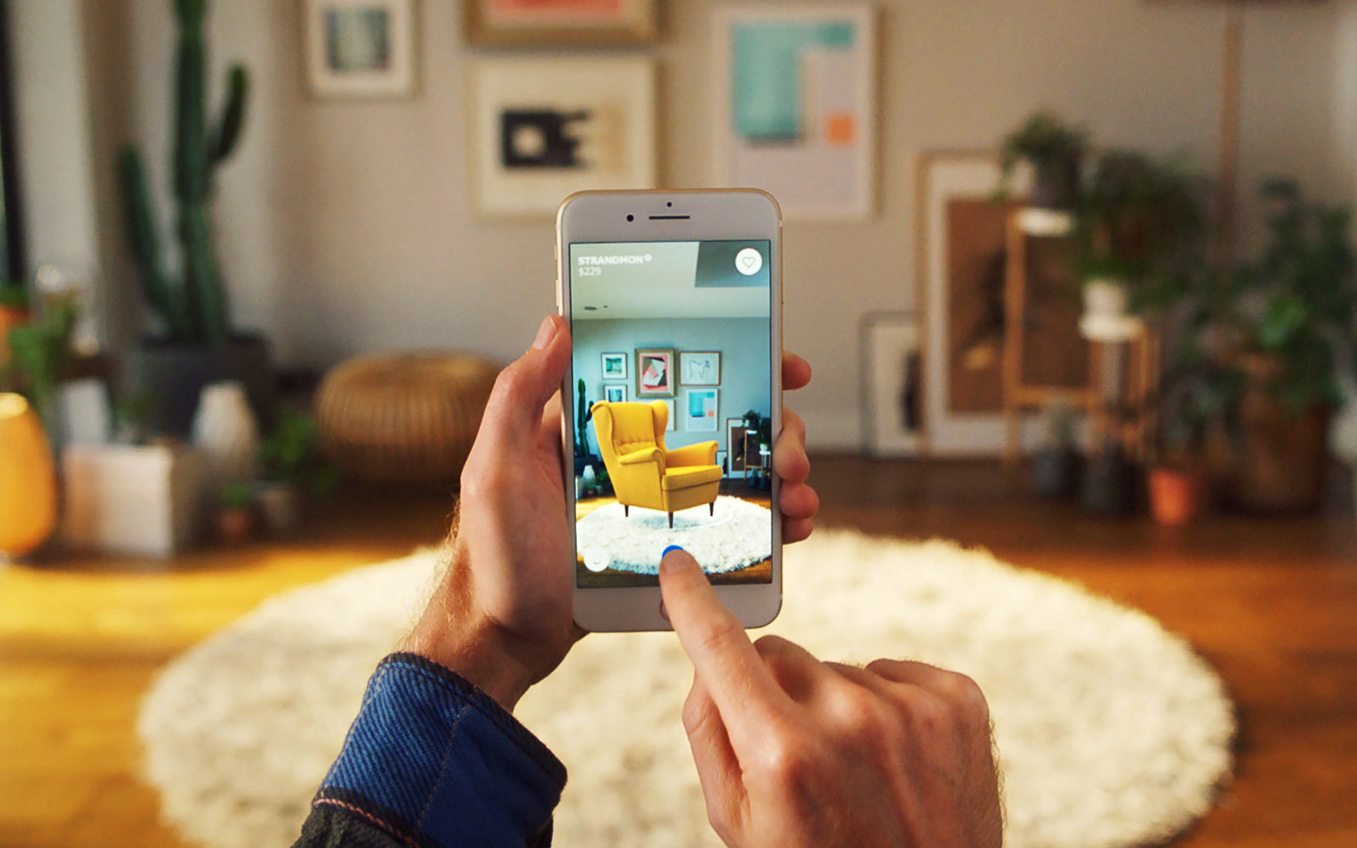 Male customer holding smart phone and decorating his room through IKEA AR App