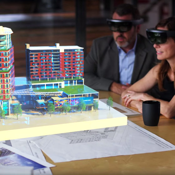 Architects look at a holographic building with Microsoft Hololens