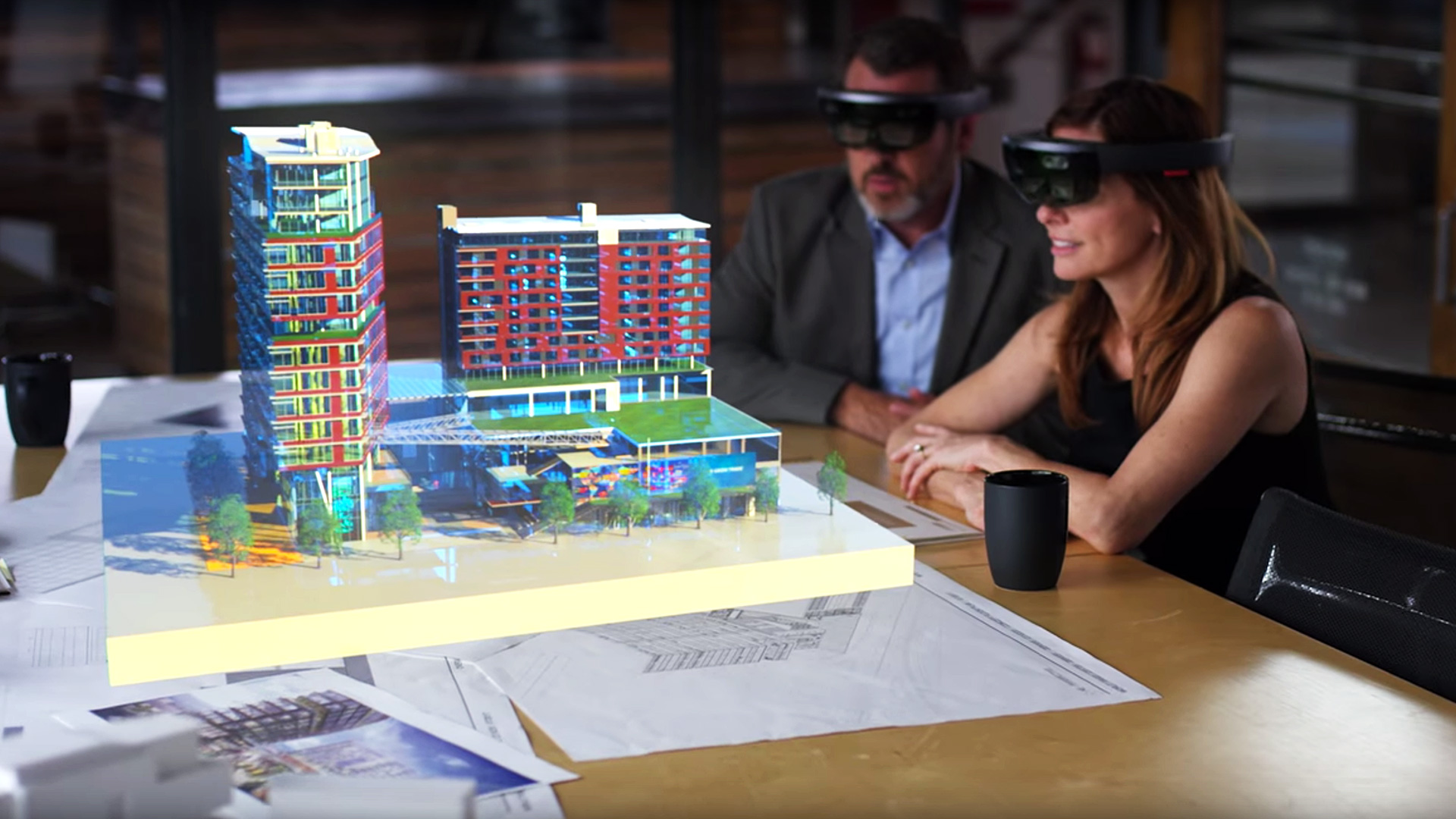 Architects look at a holographic building with Microsoft Hololens