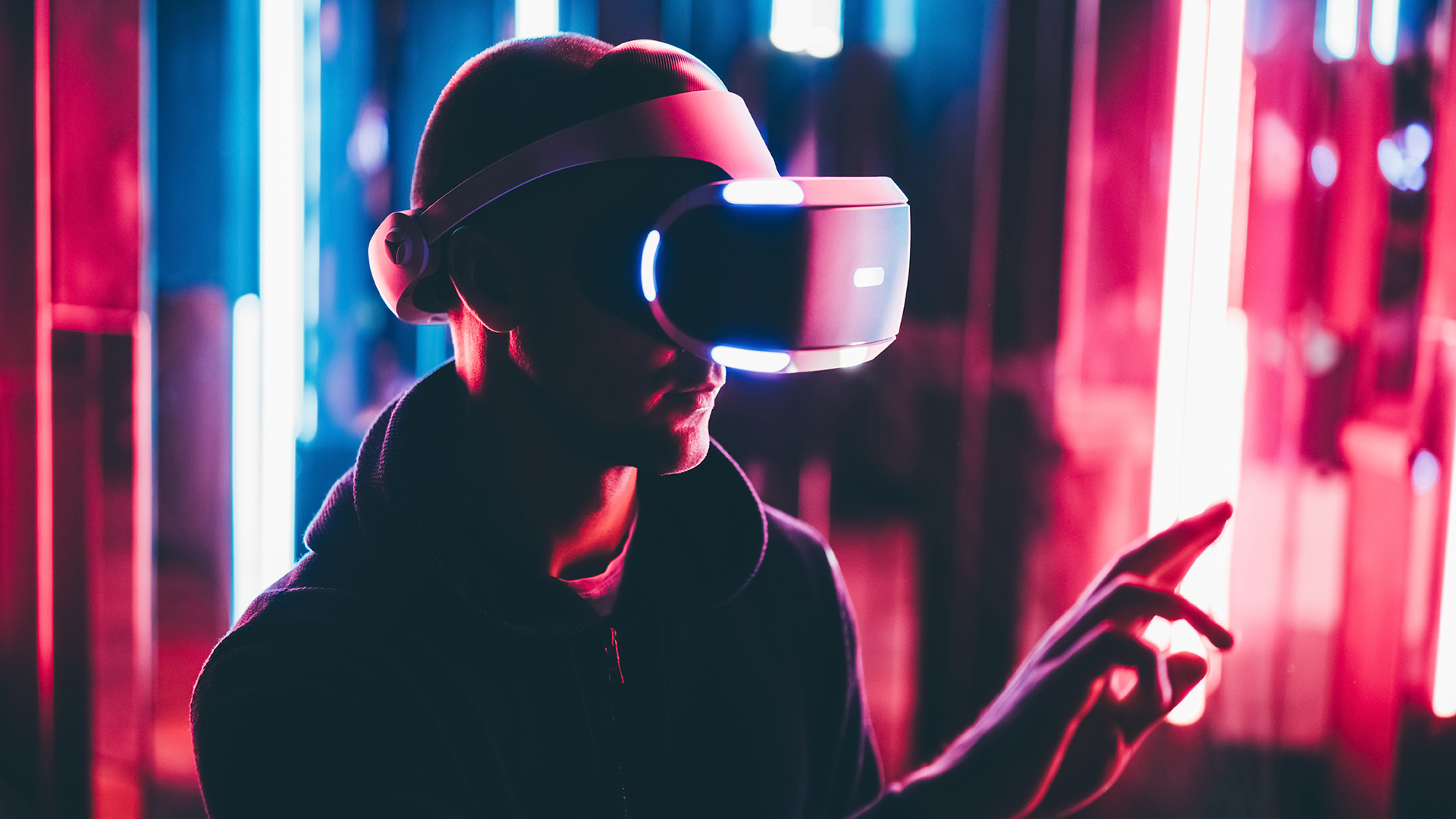 Man using VR headset touching virtual objects