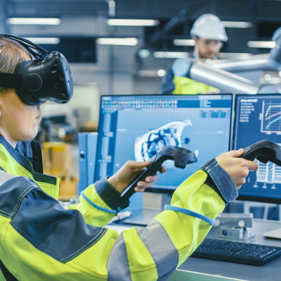 female factory worker wearing a vr headset and holding controllers for an industrial training application in an enterprise setting
