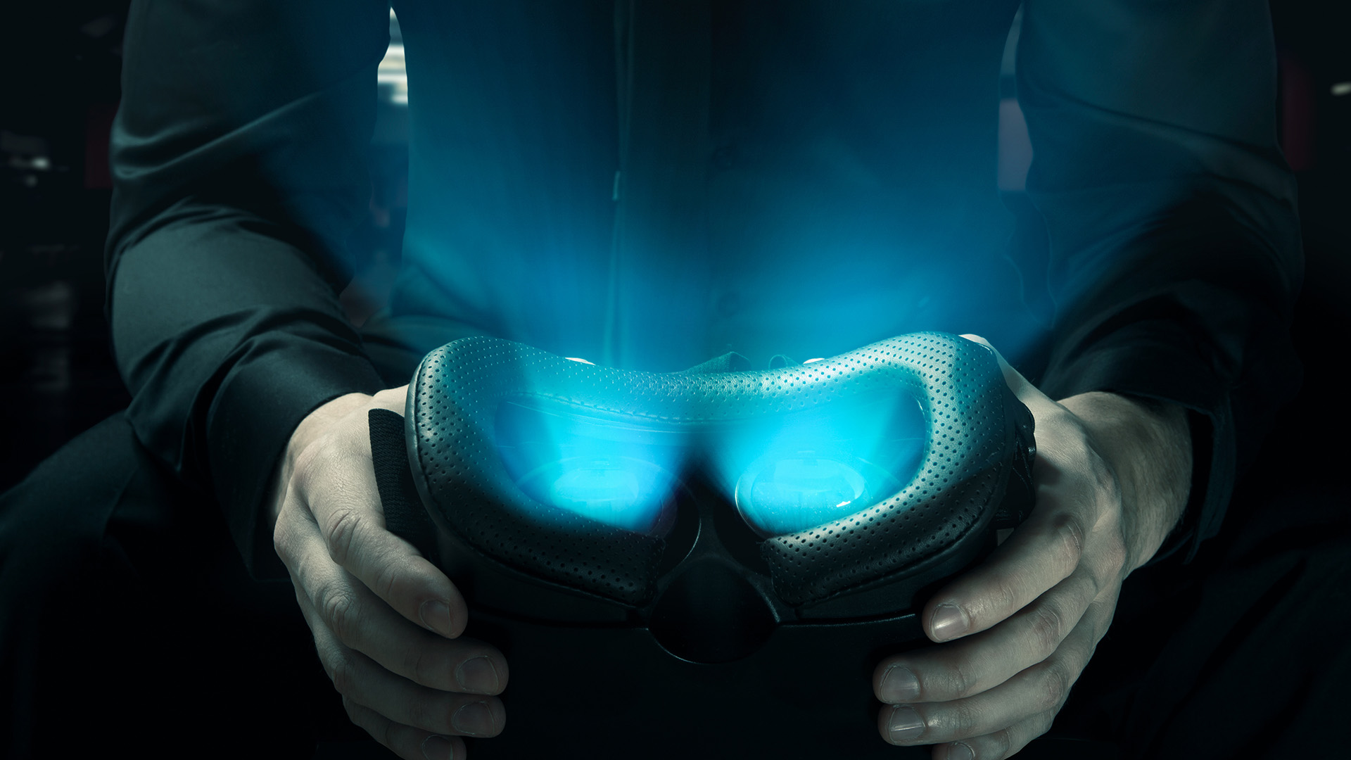 Man holds glowing VR googles that showcase immersive video