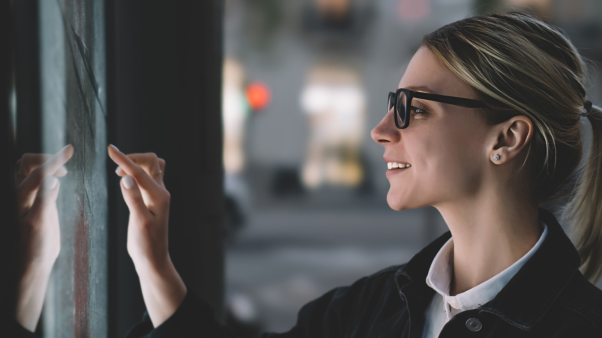 smiling female touching kiosk screen unaware of germs